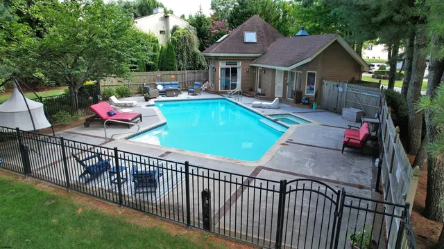 an aerial view of a house with a yard and lake view