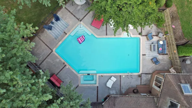 an aerial view of a house with a yard and lake view