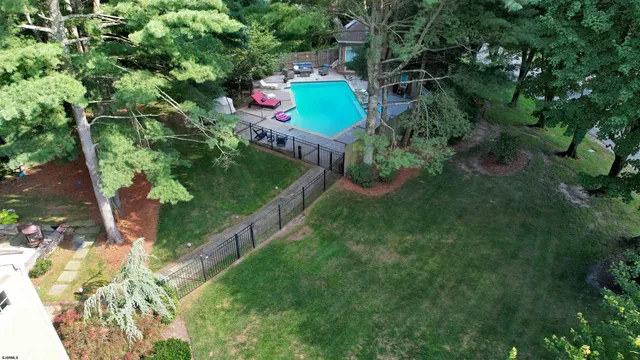 a living room with furniture a bookshelf and a window