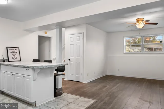 a view of a kitchen with wooden floor and electronic appliances