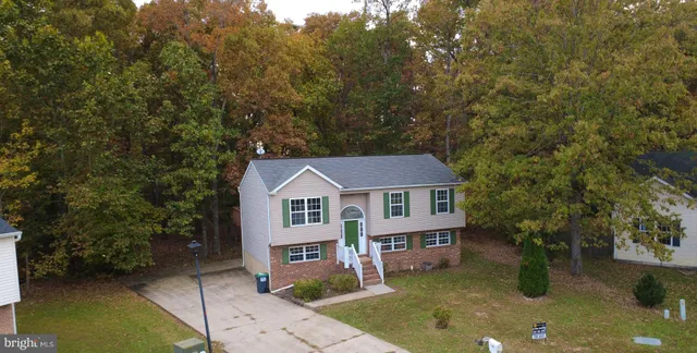 an aerial view of residential houses with yard