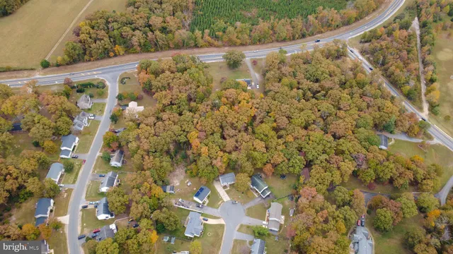 an aerial view of residential house with outdoor space and parking