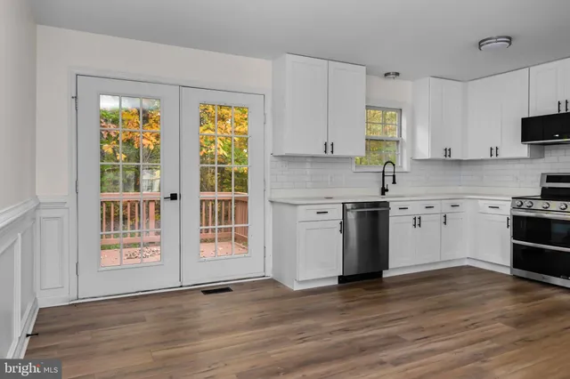 a kitchen with stainless steel appliances a stove top oven and a refrigerator