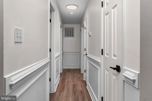 a view of a hallway with a hardwood