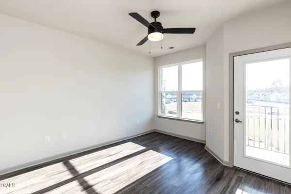 a view of wooden floor and windows in a room