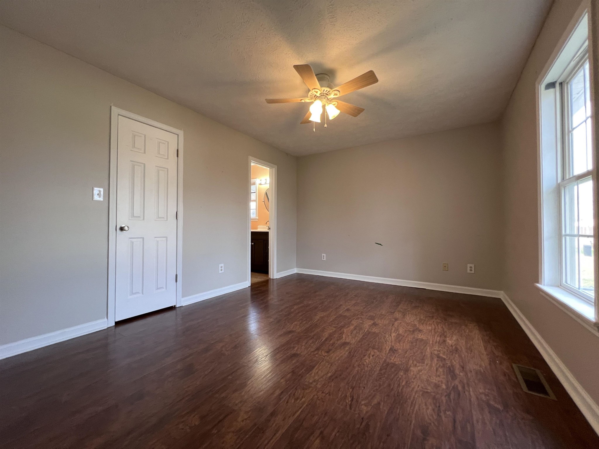 530 Stout Street Savannah, TN 38372 - Photo 13 of 39 a view of an empty room with wooden floor and a window