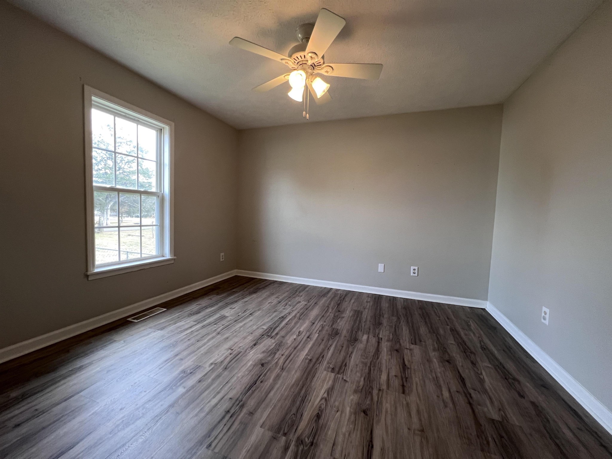 530 Stout Street Savannah, TN 38372 - Photo 19 of 39 wooden floor in an empty room with a window