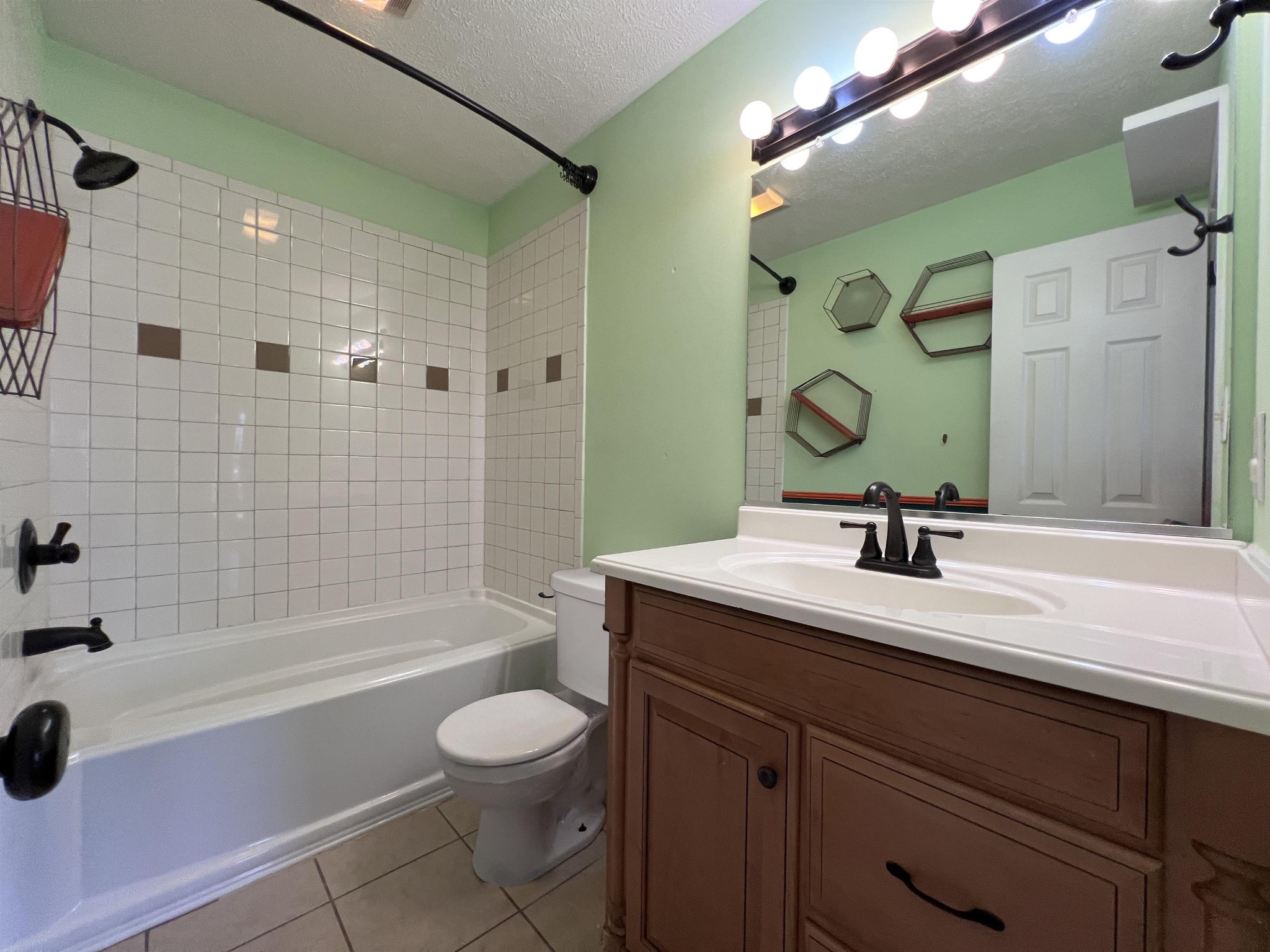 530 Stout Street Savannah, TN 38372 - Photo 21 of 39 a bathroom with a granite countertop sink a toilet and shower