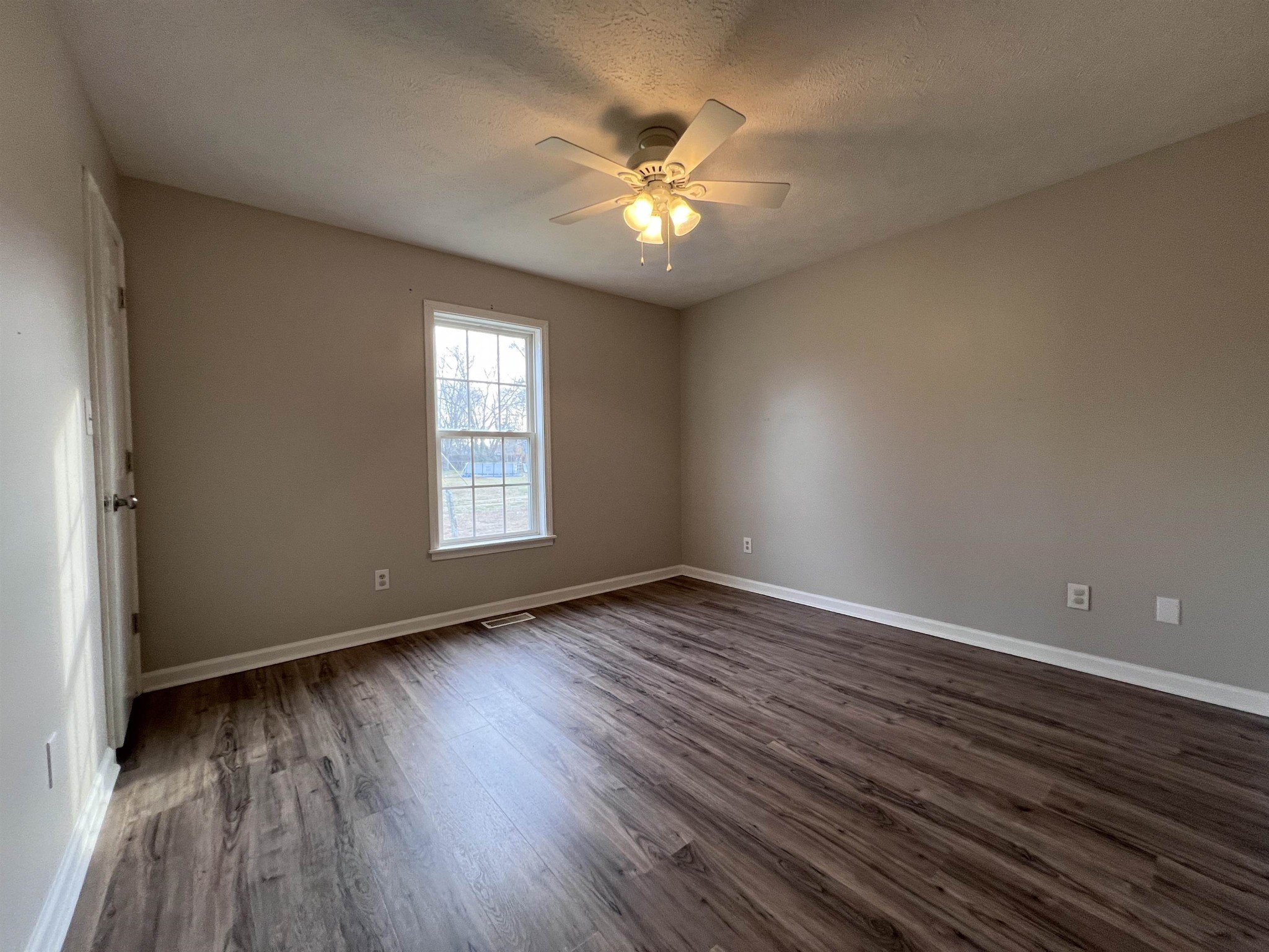 530 Stout Street Savannah, TN 38372 - Photo 23 of 39 a view of an empty room with wooden floor and a window