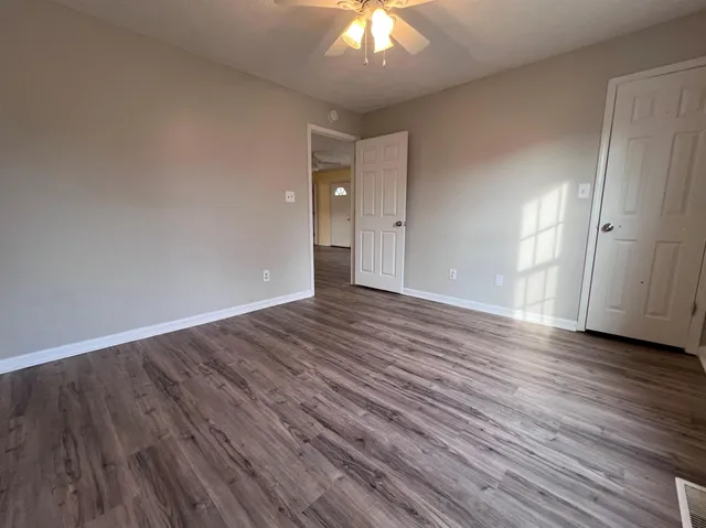 a view of an empty room and wooden floor