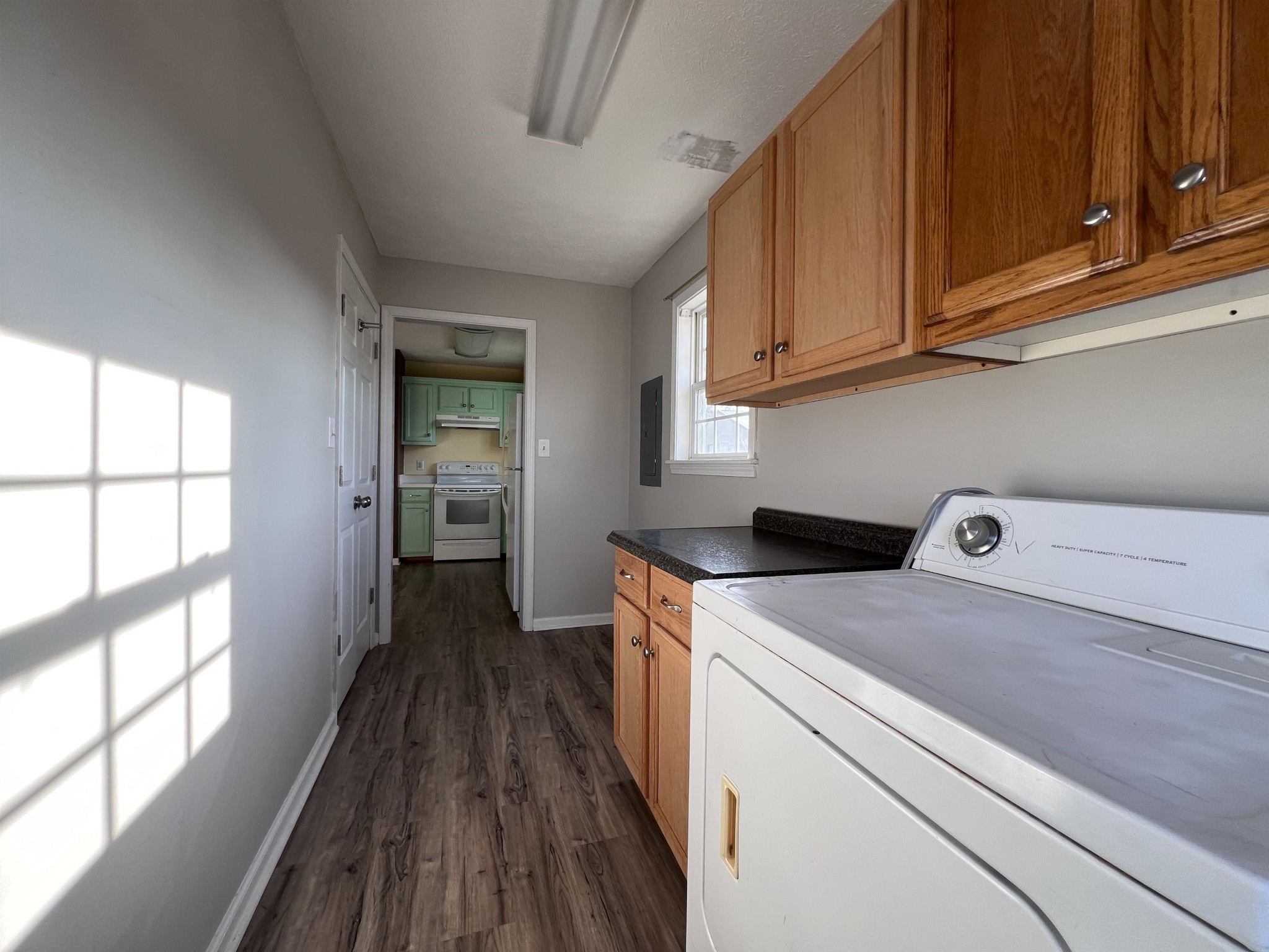 530 Stout Street Savannah, TN 38372 - Photo 25 of 39 a view of a kitchen with fridge and wooden floor