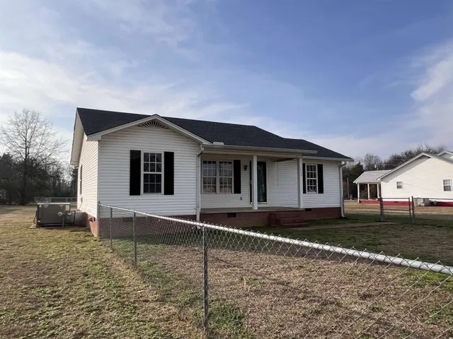 a house with trees in the background