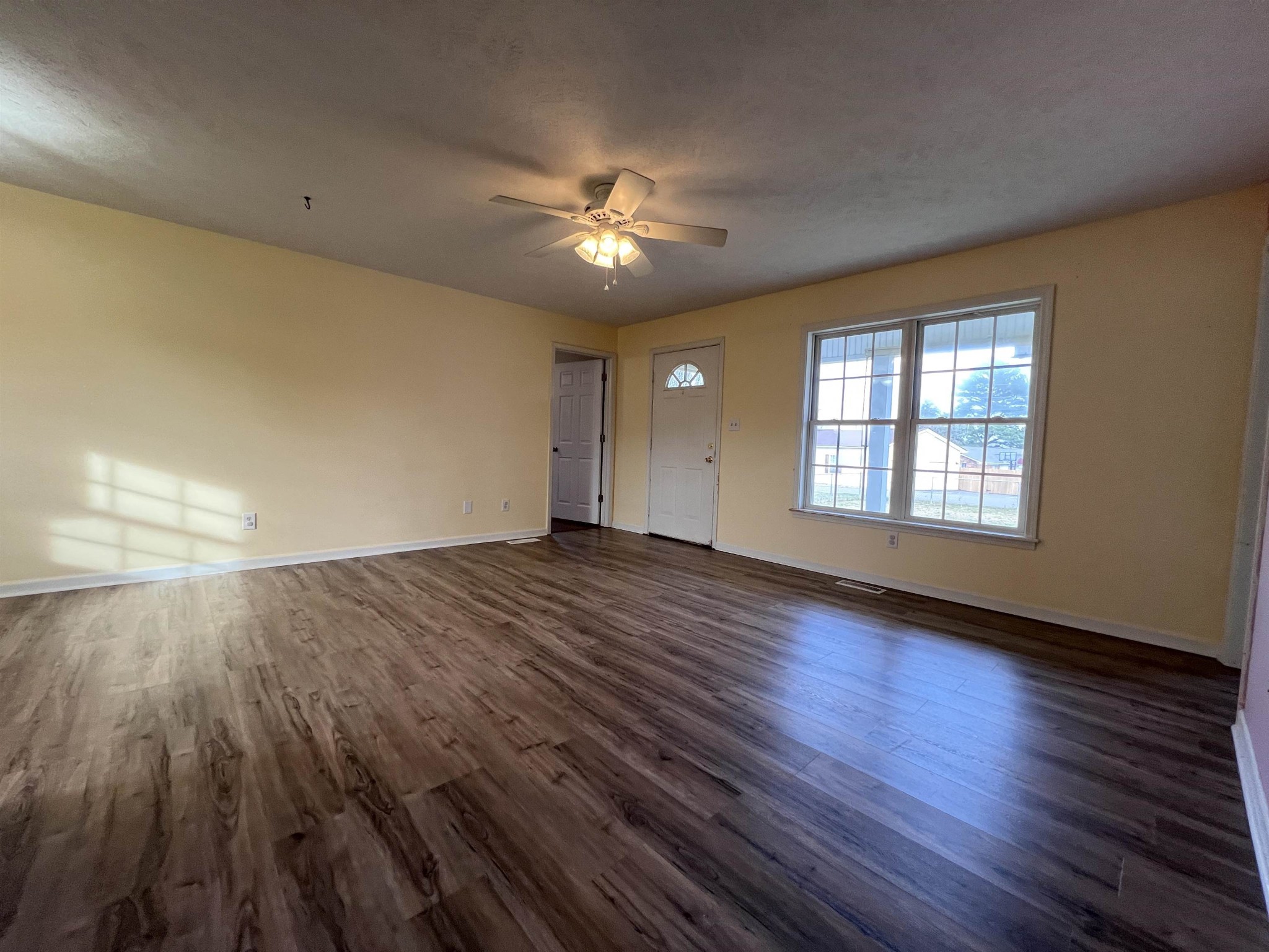 530 Stout Street Savannah, TN 38372 - Photo 4 of 39 a view of empty room with wooden floor and fan