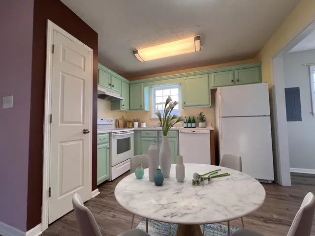 a view of a dining room with furniture and wooden floor