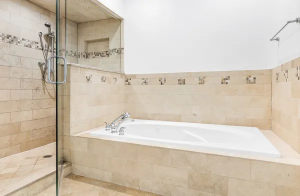 a bathroom with a bathtub and shower