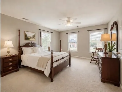 a spacious bedroom with a bed and a chandelier