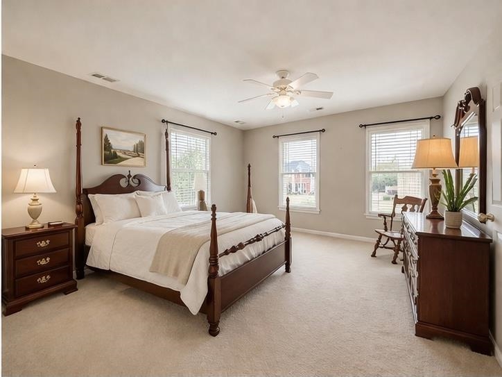 985 Collingham Cove Collierville, TN 38017 - Photo 13 of 17 a spacious bedroom with a bed and a chandelier