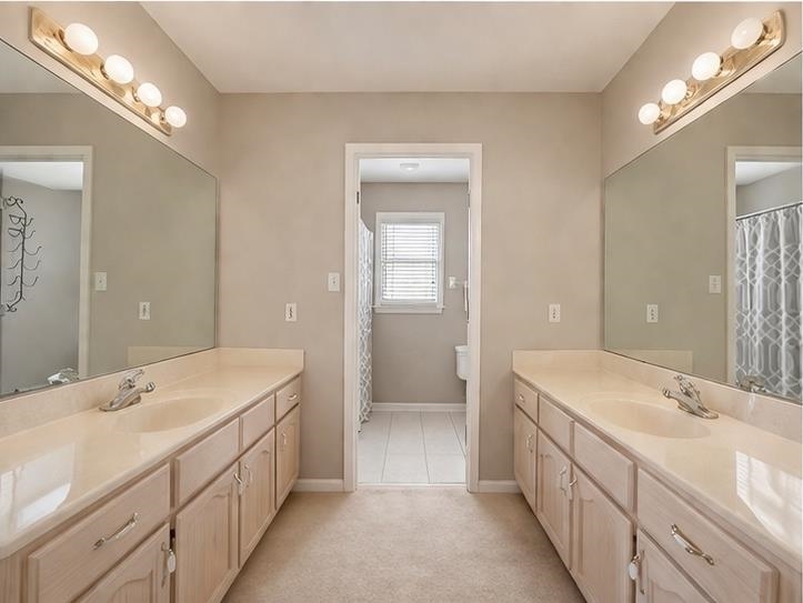 985 Collingham Cove Collierville, TN 38017 - Photo 15 of 17 a bathroom with double sink and a large mirror