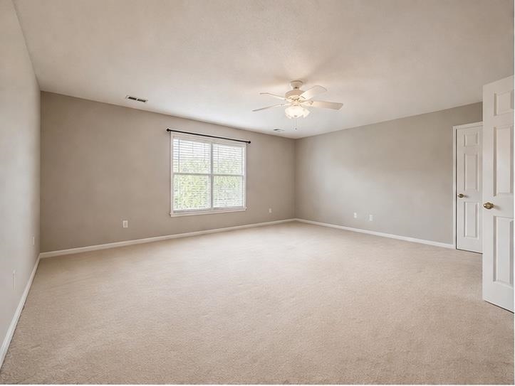 985 Collingham Cove Collierville, TN 38017 - Photo 16 of 17 an empty room with a ceiling fan and window