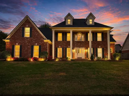 a front view of a house with a garden