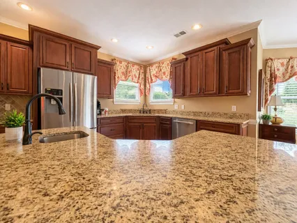 a large kitchen with kitchen island granite countertop a granite counter tops and a sink