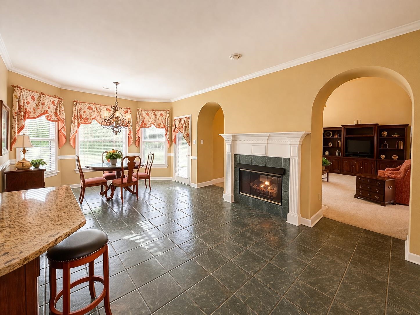 985 Collingham Cove Collierville, TN 38017 - Photo 8 of 17 a living room with furniture a fireplace and a dining table with floor to ceiling window