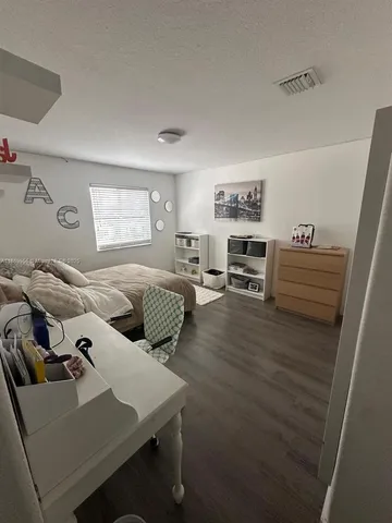 a bedroom with furniture and a window