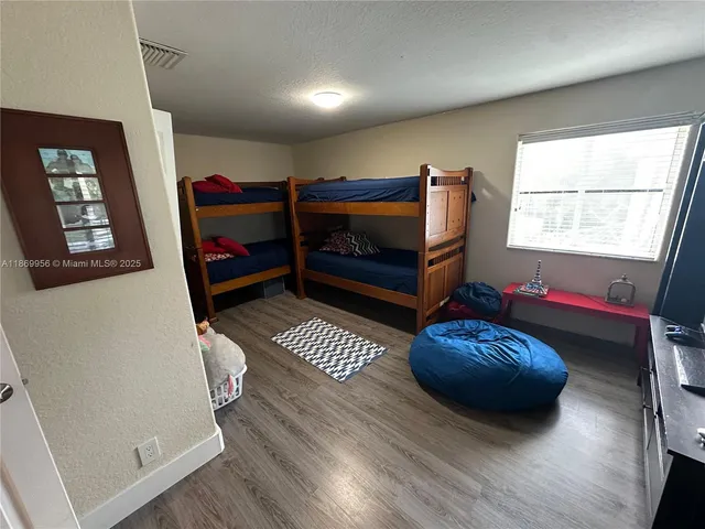 a bedroom with furniture and a window