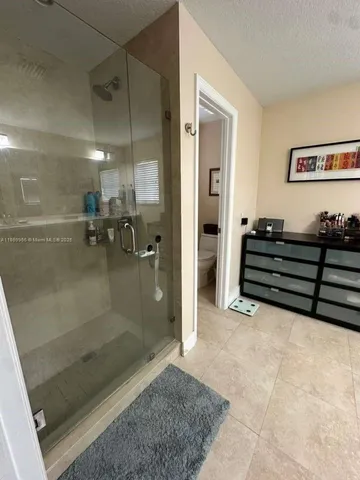 a white toilet sitting next to a sink