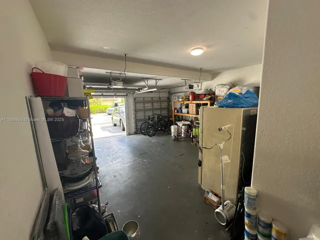 a view of swimming pool with chairs in front of house