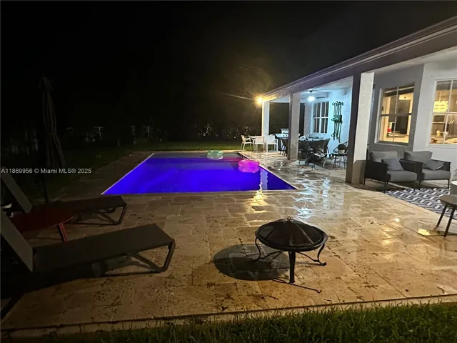 a view of swimming pool with seating area