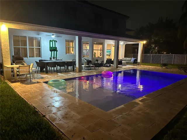 a view of swimming pool with outdoor seating