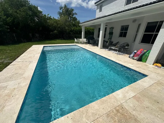 a front view of house with yard and outdoor seating