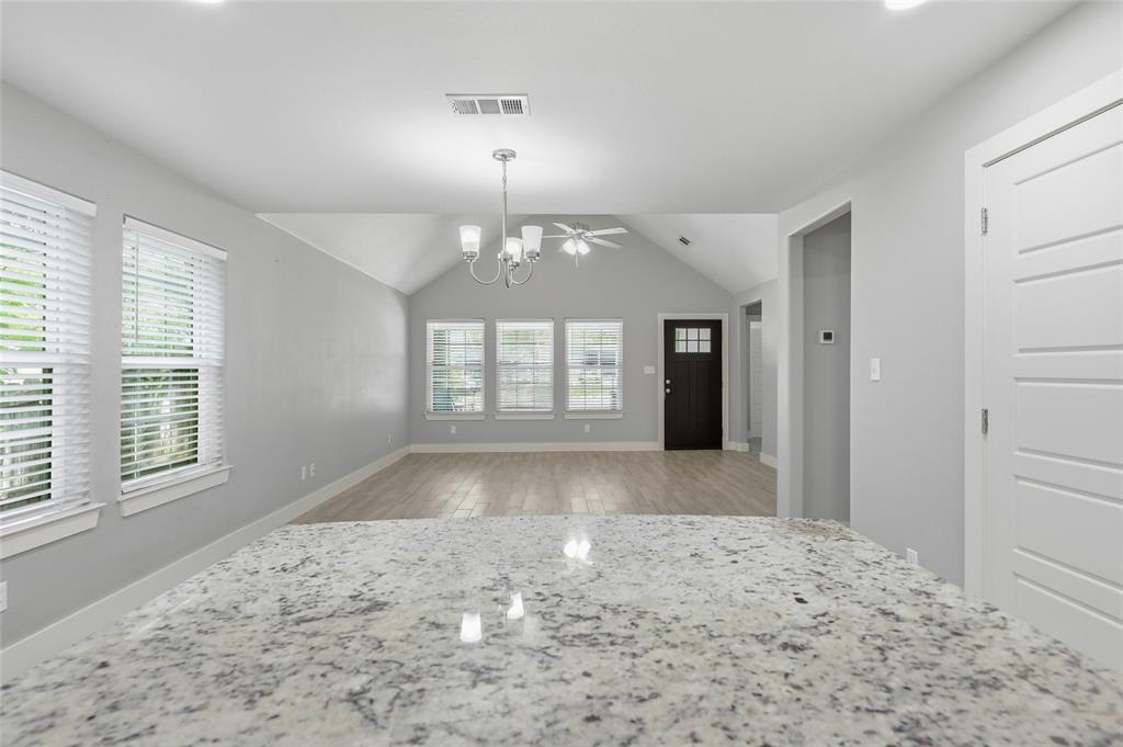 318 Munson Street Denison, TX 75021 - Photo 7 of 21 a view of a big room with windows and chandelier fan