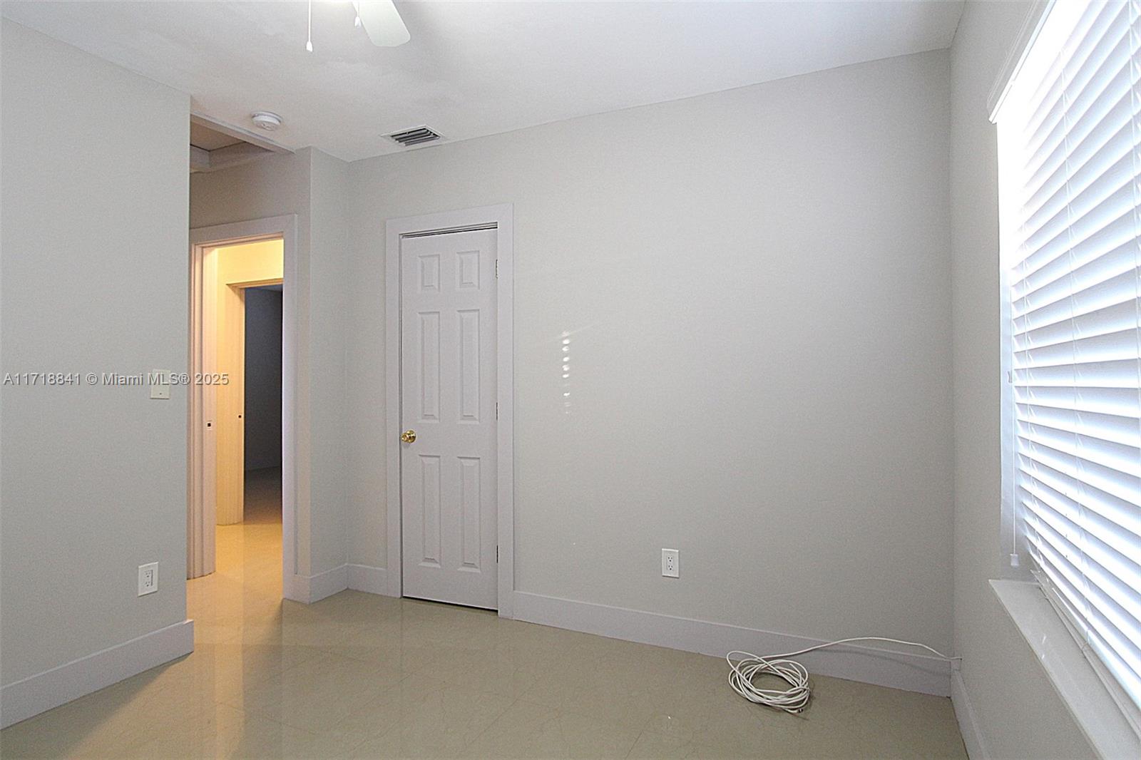 14340 Graves Drive Miami, FL 33176 - Photo 12 of 16 an empty room with windows and closet