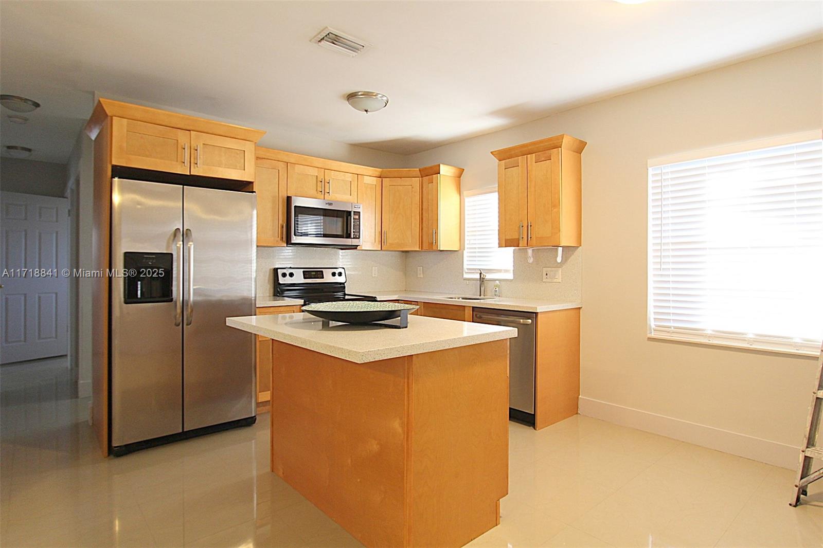 14340 Graves Drive Miami, FL 33176 - Photo 5 of 16 a kitchen with stainless steel appliances granite countertop a stove a refrigerator a sink a stove and island