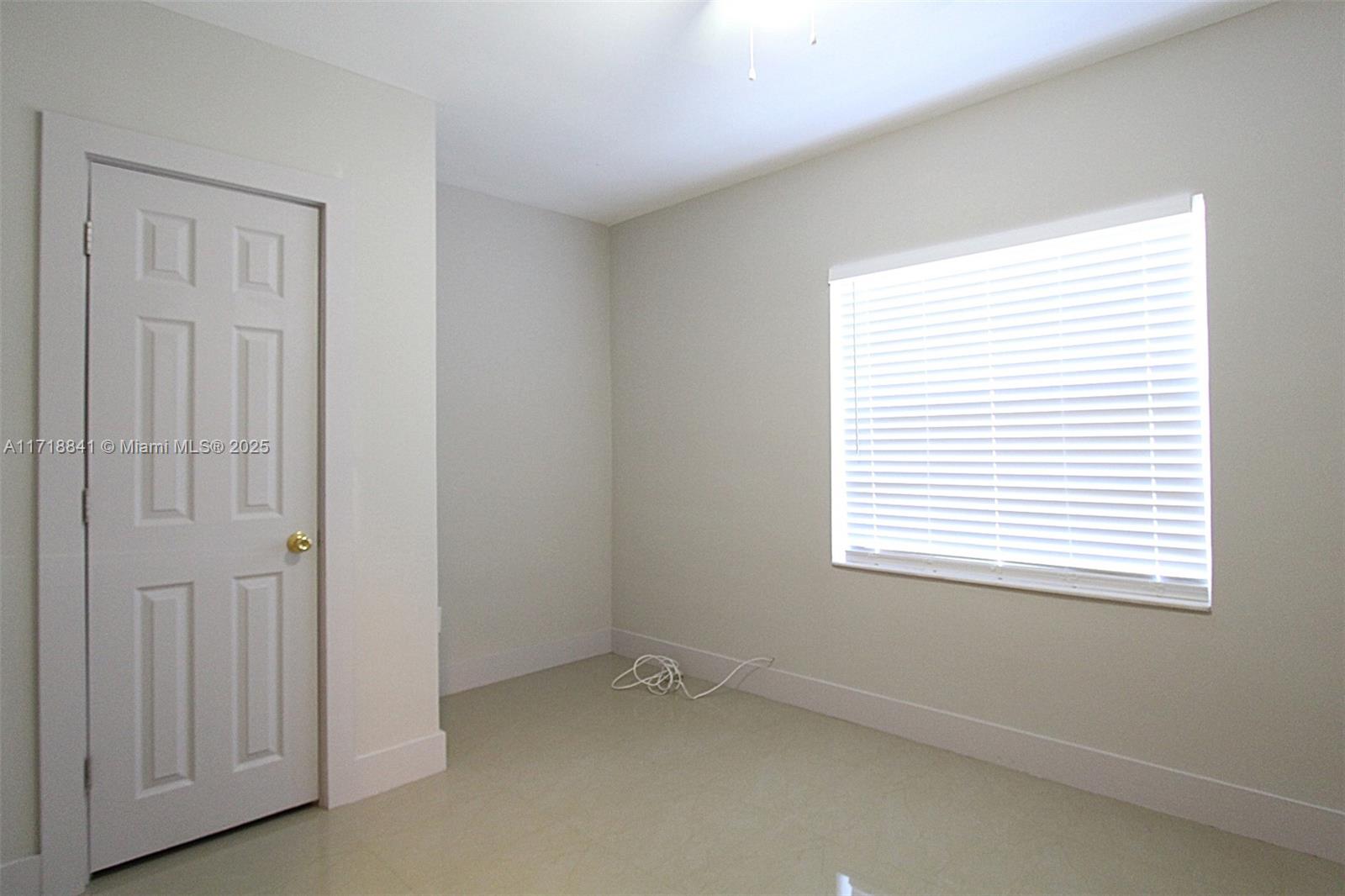 14340 Graves Drive Miami, FL 33176 - Photo 7 of 16 a view of an empty room with a window