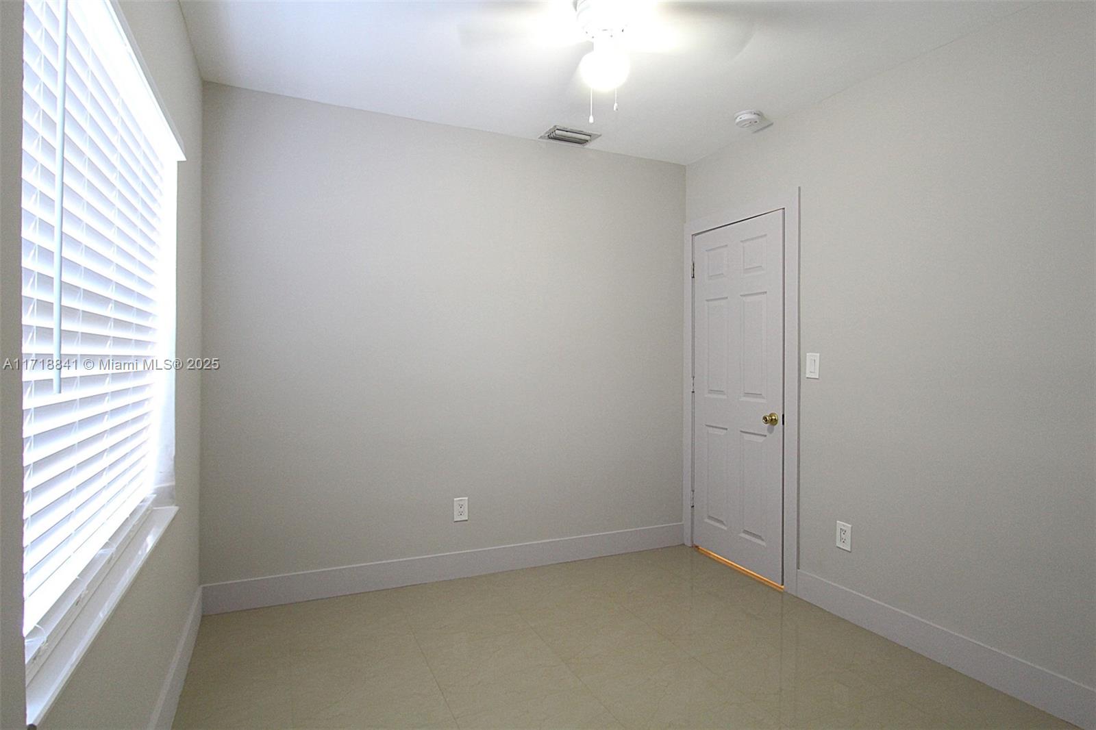 14340 Graves Drive Miami, FL 33176 - Photo 8 of 16 an empty room with a window