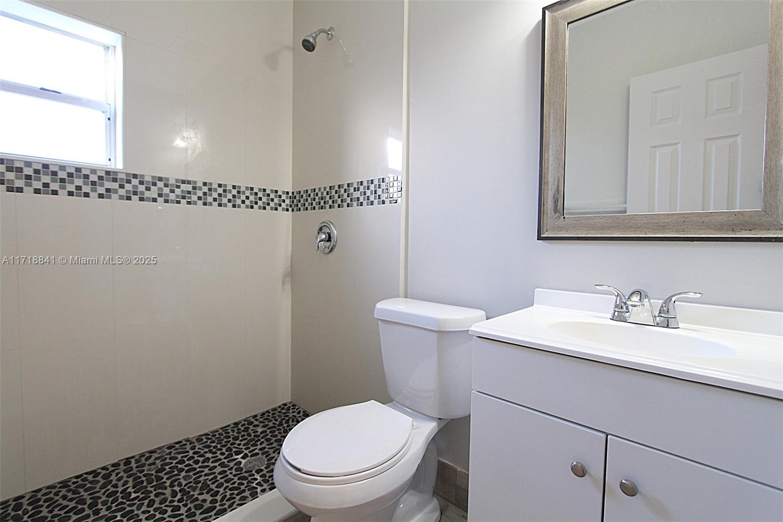 14340 Graves Drive Miami, FL 33176 - Photo 10 of 16 a bathroom with a granite countertop toilet sink and mirror