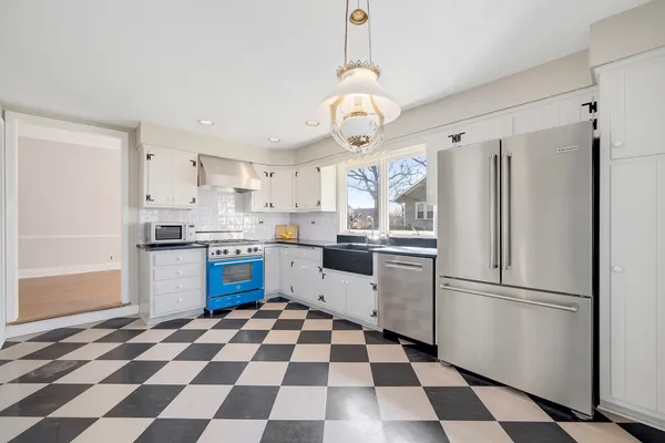 a kitchen with a refrigerator a sink and a stove