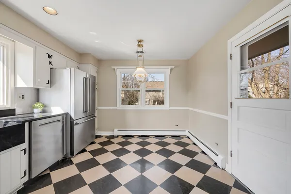 a kitchen with a checkered floor and a window
