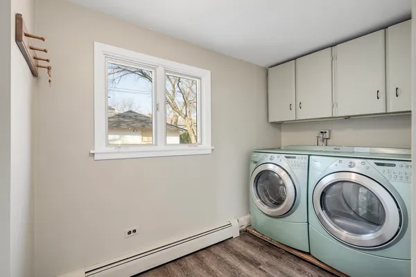a utility room with sink dryer and washer