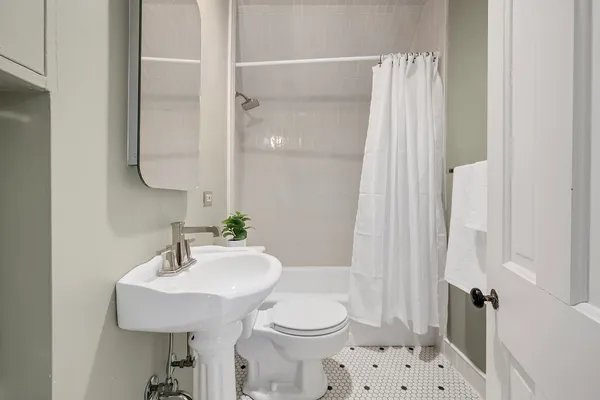 a bathroom with a sink toilet and shower