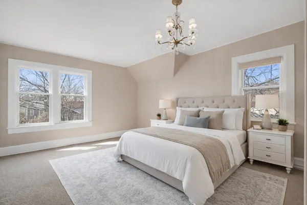 a spacious bedroom with a large bed and a window