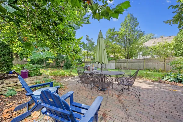 a view of a chairs and table in patio with a yard