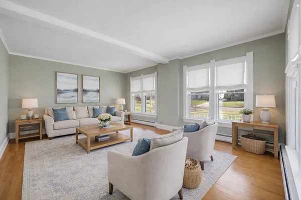 a living room with furniture large window and table