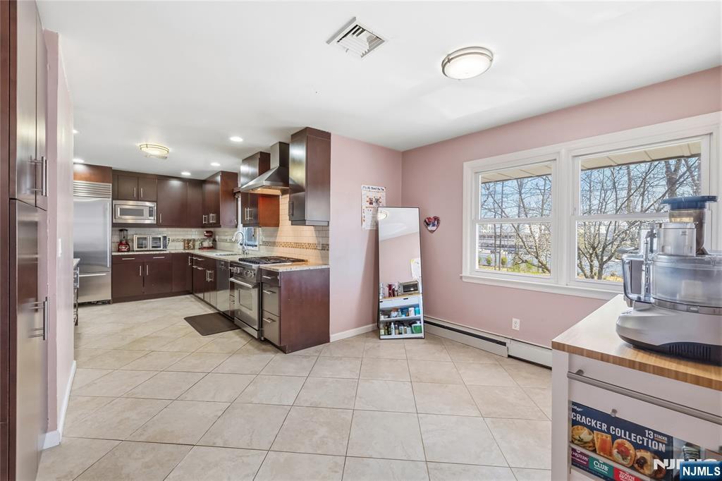 682 Floyd Street Englewood Cliffs, NJ 07632 - Photo 11 of 33 a kitchen with stainless steel appliances granite countertop a refrigerator and a sink