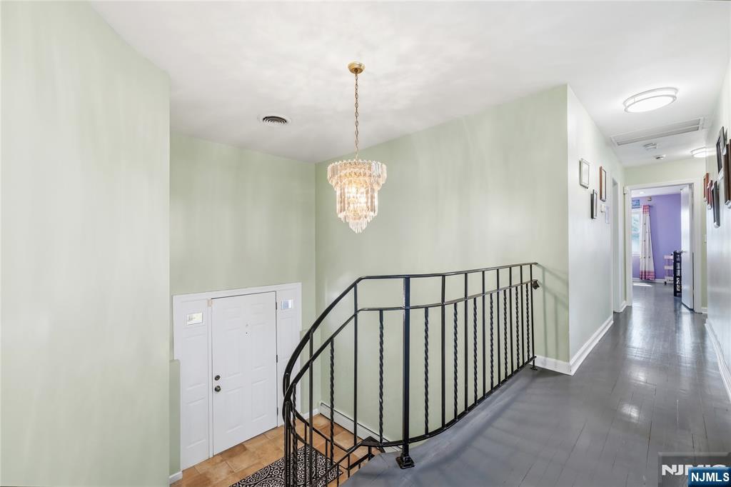 682 Floyd Street Englewood Cliffs, NJ 07632 - Photo 13 of 33 a view of a hallway with wooden floor and stairs