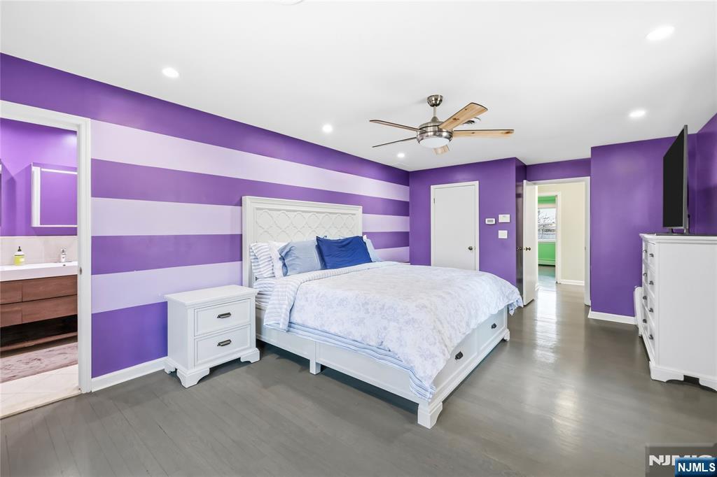 682 Floyd Street Englewood Cliffs, NJ 07632 - Photo 15 of 33 a spacious bedroom with a bed and a chandelier