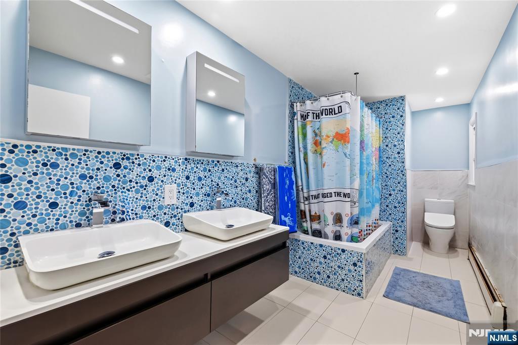 682 Floyd Street Englewood Cliffs, NJ 07632 - Photo 22 of 33 a bathroom with a bathtub sink mirror and toilet